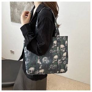 Close-up of skull and purple floral print on large black oxford cloth shoulder bag