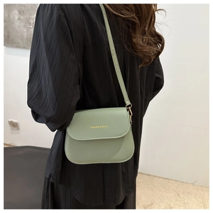 Sage green minimalist crossbody bag with gold fashion lettering and metal hardware details