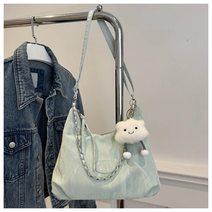 Mint green pleated nylon tote bag with silver chain and white cloud plush charm