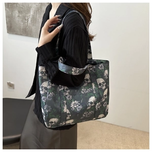Detail of skull floral print tote bag worn by model showing large capacity and strap