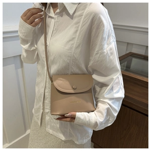 Detail of beige faux leather square crossbody bag featuring Fashion & Bags logo print