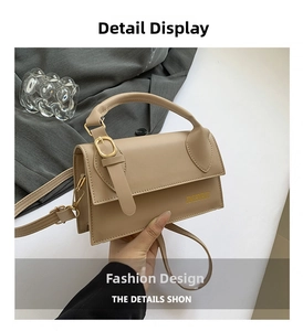 Close-up of light brown textured handbag with gold buckle and brand logo detail