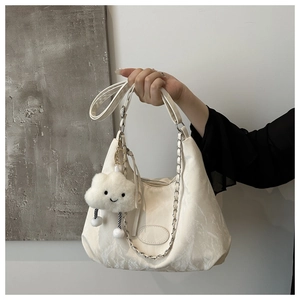 Close-up of white marble texture tote bag with silver chain and cute cloud charm