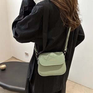 Minimalist light green leather saddle bag for women with gold fashion lettering