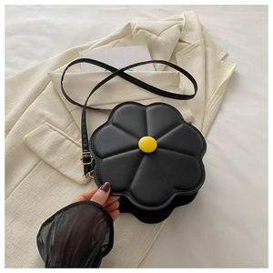 Detailed view of black flower shaped crossbody bag with 3D petals and yellow button