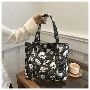 Detailed view of skull and floral print tote bag with reinforced handles for women