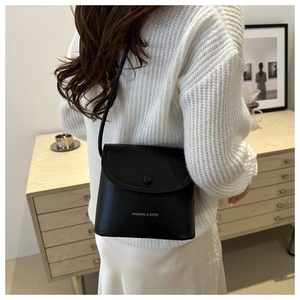Lifestyle shot of black square flap bag with Fashion & Bags print on matte leather