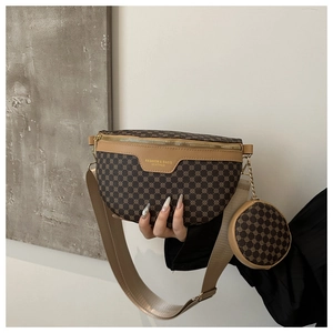 Detail of a brown moon-shaped belt bag with gold hardware and a detachable round pouch