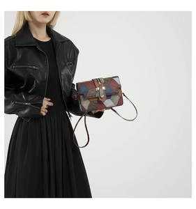 Fashionable patchwork square bag with crocodile pattern and golden clasp on a model