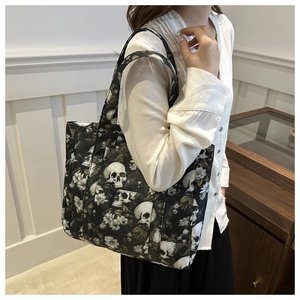 Detailed view of tote bag featuring gothic skull and floral pattern on thick canvas