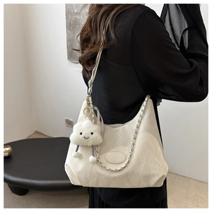 Beige oversized shoulder bag with metallic chain and a cute cloud plush charm detail
