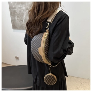 Detail of trendy retro crossbody fanny pack with a detachable round coin purse on a wide strap