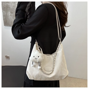 Detail of white pleated shoulder bag with metal chain strap and cute cloud charm