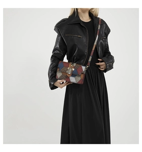 Detail of bohemian patchwork leather crossbody bag showing colorful texture and strap