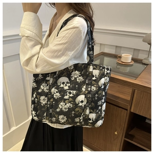 Close-up of lifestyle use showing the skull and floral print canvas tote bag on shoulder