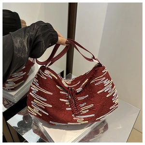 Close-up of burgundy hobo bag with FF embossing and colorful wavy embroidered stripes