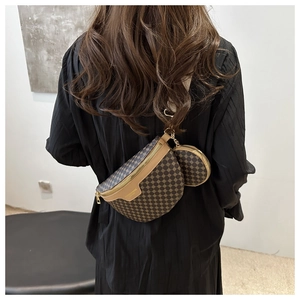 Detail view of two-in-one crescent belt bag with round pouch in vintage brown leather
