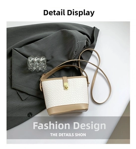 Detail of woven bucket bag featuring khaki leather trim and gold buckle clasp