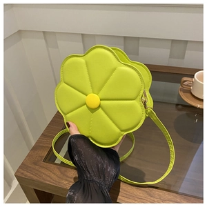Detail view of the floral crossbody bag in lime green with textured petal stitching