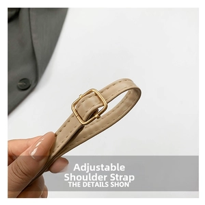 Detailed macro view of beige faux leather adjustable shoulder strap with gold buckle