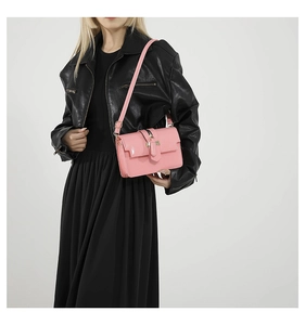 Fashionable pink square shoulder bag shown on a model wearing a black leather coat