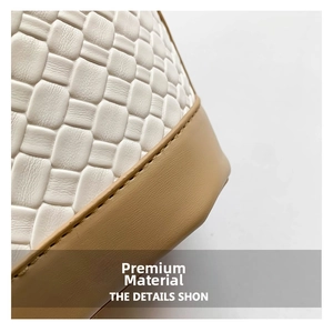 Detail of white woven leather bucket bag with khaki stitching and smooth trim
