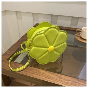 Close-up of neon green flower-shaped crossbody bag with yellow center button detail