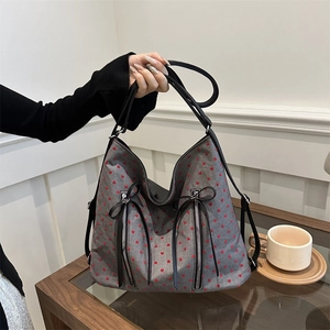 Minimalist grey tote bag with red heart prints and decorative black leather bows