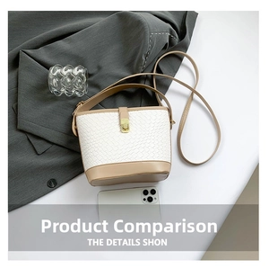 Close-up of woven bucket bag featuring khaki trim and a gold rectangular metal clasp