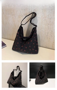 Dettaglio borsa tote in velluto a coste nero con ricamo fragola e tracolla regolabile