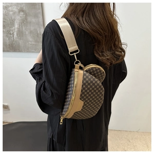 Detail view of a vintage crossbody bag with a round coin purse and wide fabric strap