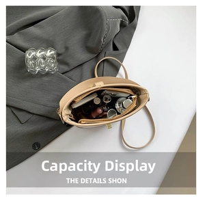 Flat lay of open beige crossbody bag showing interior storage capacity with daily items