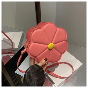 Detailed view of pink floral petal handbag with yellow center button and leather strap