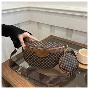 Detailed view of brown monogram fanny pack with a small round pouch on a wooden table