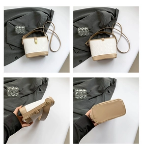 Detail view of woven contrast bucket bag with gold rotary clasp and adjustable strap