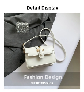 Close-up of white PU leather square bag with golden buckle and fine stitching detail