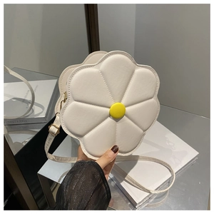 Close-up of a white flower-shaped crossbody bag with a yellow center and gold buckle
