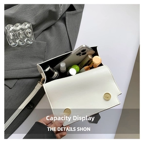 Interior capacity display of white square shoulder bag showing phone and cosmetics