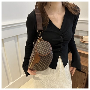 Detail of vintage geometric pattern chest bag with detachable round coin purse and gold hardware