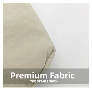 Detailed close-up of premium beige fabric texture showing subtle folds on a tote bag