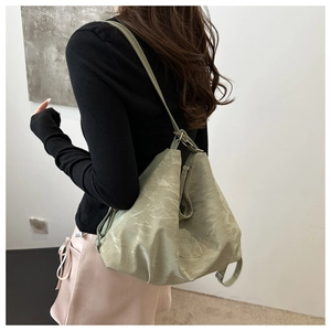 Detailed shot of large light green tote bag with marble textured PU leather and logo