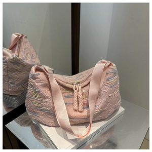 Detailed macro of pink fabric texture with colorful rhythmic striped embroidery and strap
