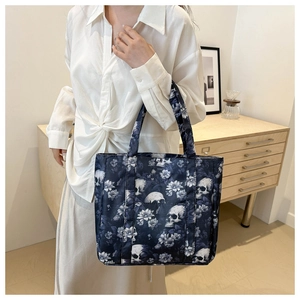 Detail of Oxford fabric shoulder bag featuring white skull and floral prints for women