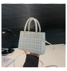 Detail of tweed weave pattern and gold hardware on the white luxury plaid crossbody bag