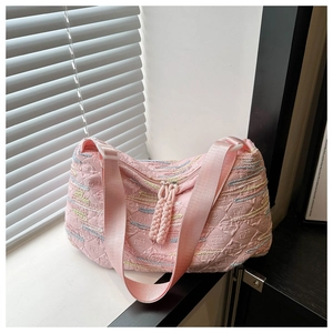 Detail of pink embroidered crossbody bag with rhythmic stripes and embossed textures
