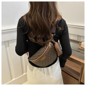 Rear view of model wearing a brown monogram waist bag with a mini round coin purse