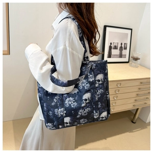 Detail of navy blue skull floral tote bag showing large capacity and side profile on a model