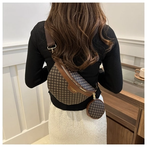Detail view of the monogram crossbody bag and round coin pouch set on model