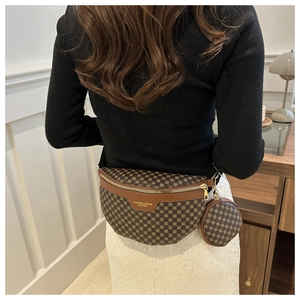 Detail view of a vintage patterned fanny pack with a detachable round coin purse on a model