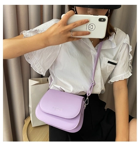 Detail view of light purple saddle bag with adjustable strap and Fashion & Trend text